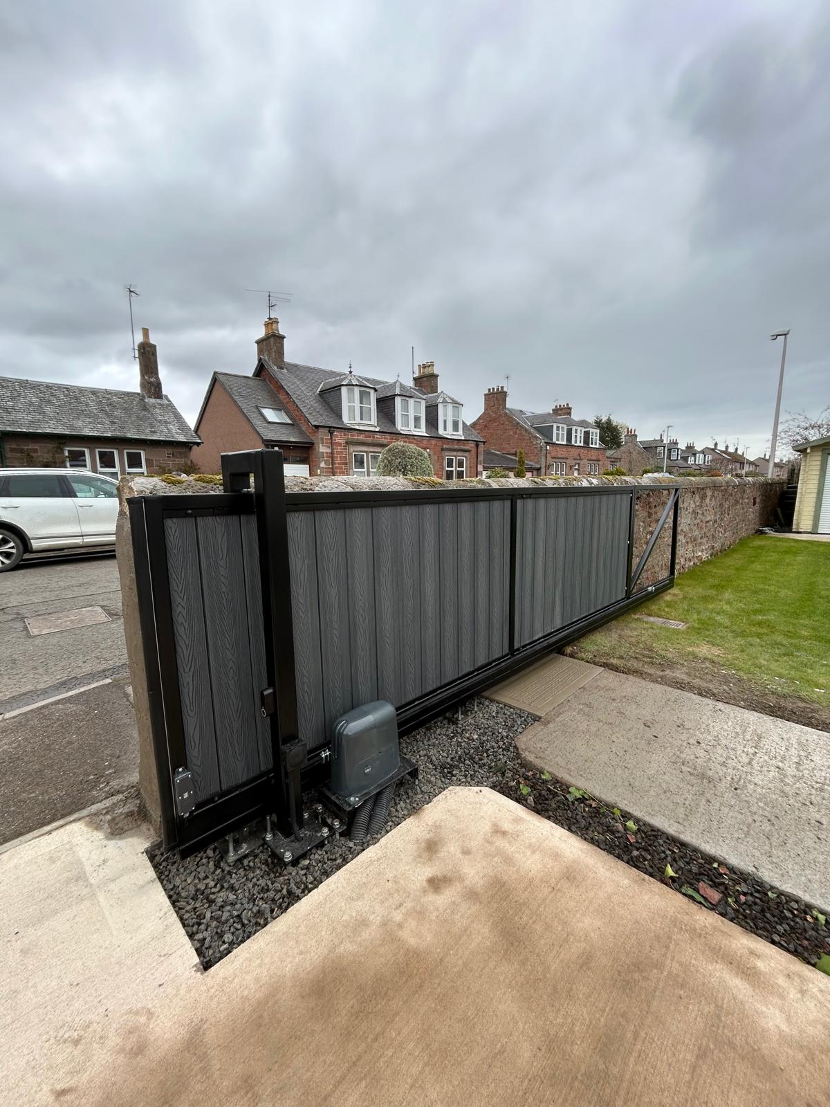 Composite cantilever sliding gate with streetside installation by KLR Design